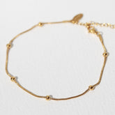 Pulsera de tobillo con bolas doradas