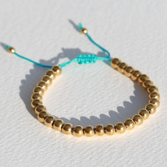 Armband gouden kraal blauw