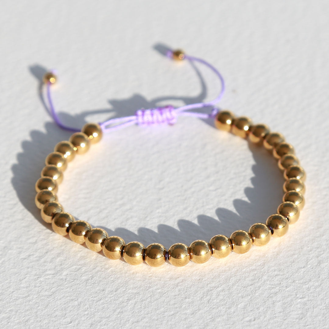 Armband gouden kraal lila