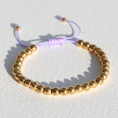 Armband gouden kraal lila