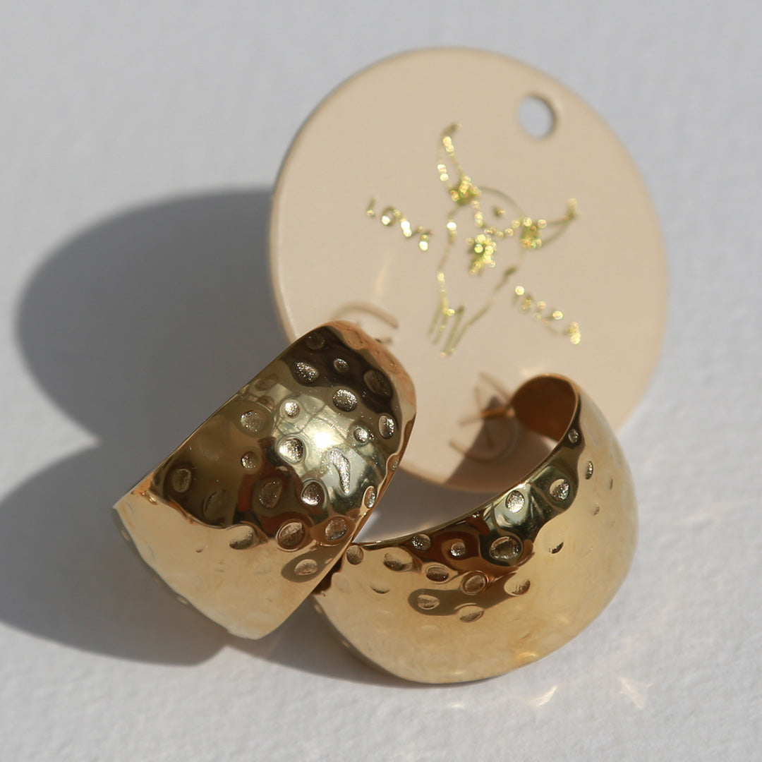 Gold earrings bold statement